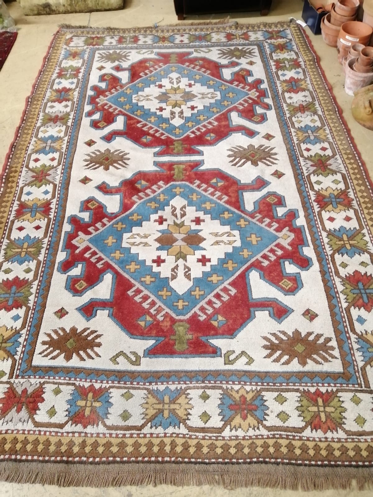 A Caucasian design ivory ground carpet, 270 x 172cm